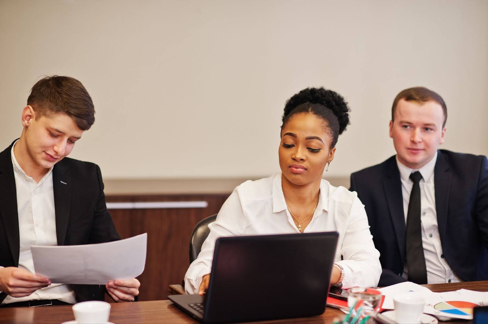 A group of attorneys reviewing notes and documents at a table, representing discovery in personal injury cases in Georgia, which signals the beginning of this chess match.